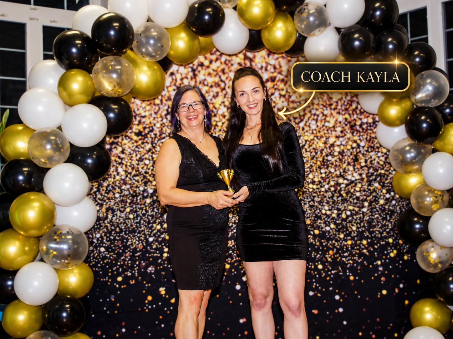 Coach Kayla with a member at the Little Black Dress Party